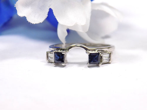 This is a white gold sapphire and diamond ring guard or wrap shown without a solitaire in the middle.