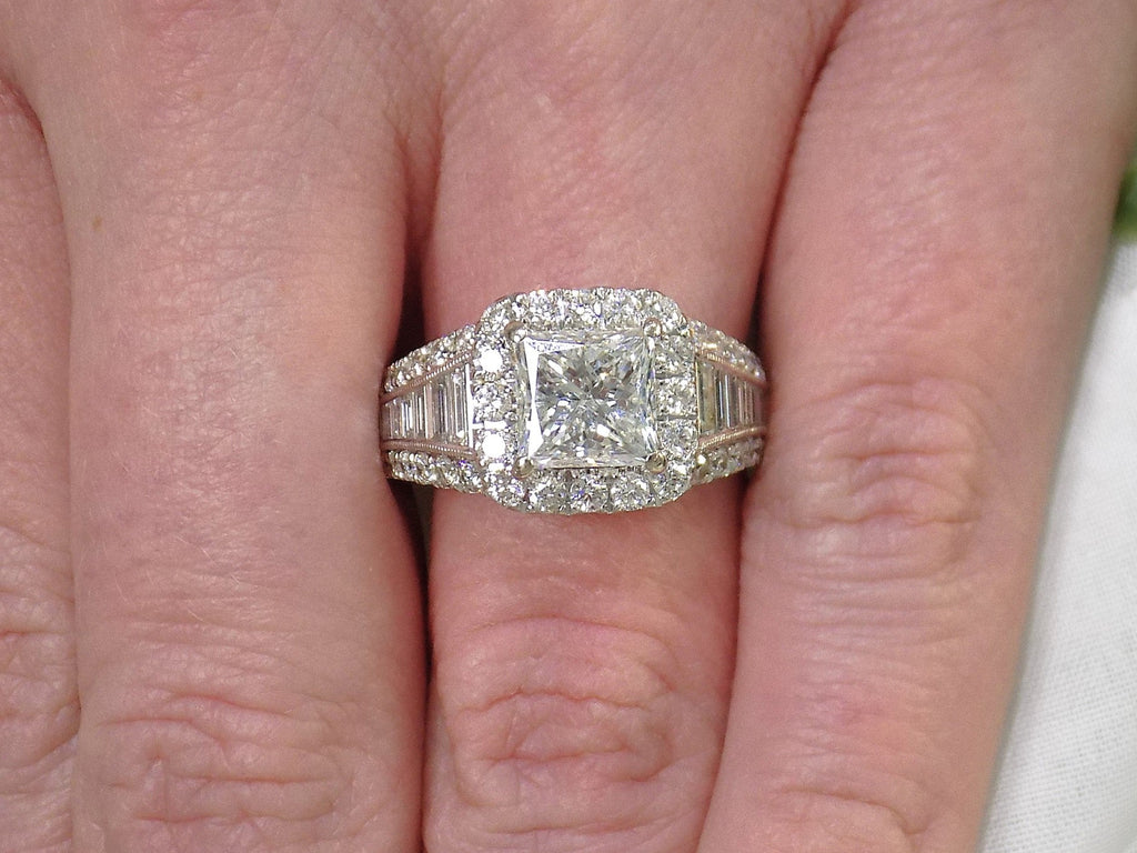 This is 3.68ct total weight natural diamond ring with a 2.05ct natural princess cut set in a legendary designer Simon G white gold mounting shown on a woman's finger.