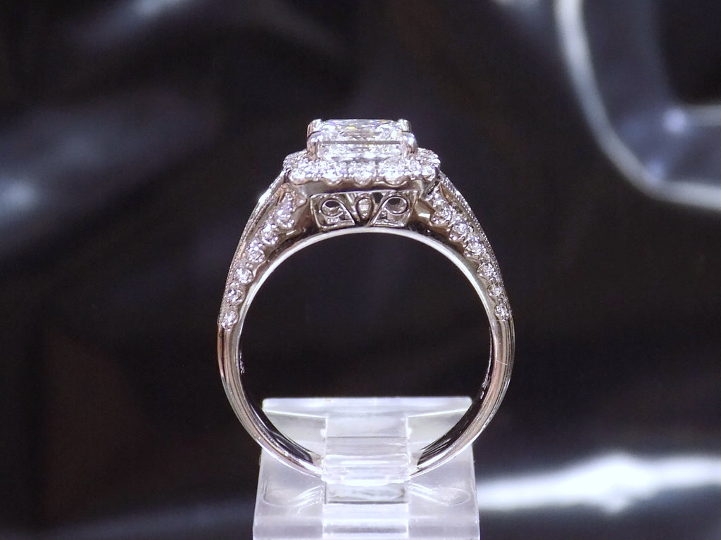This is a side view of a 3.68ct total weight natural diamond ring with a 2.05ct natural princess cut set in a legendary designer Simon G white gold mounting with a black background.