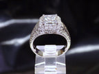This is 3.68ct total weight natural diamond ring with a 2.05ct natural princess cut set in a legendary designer Simon G white gold mounting with a black background.