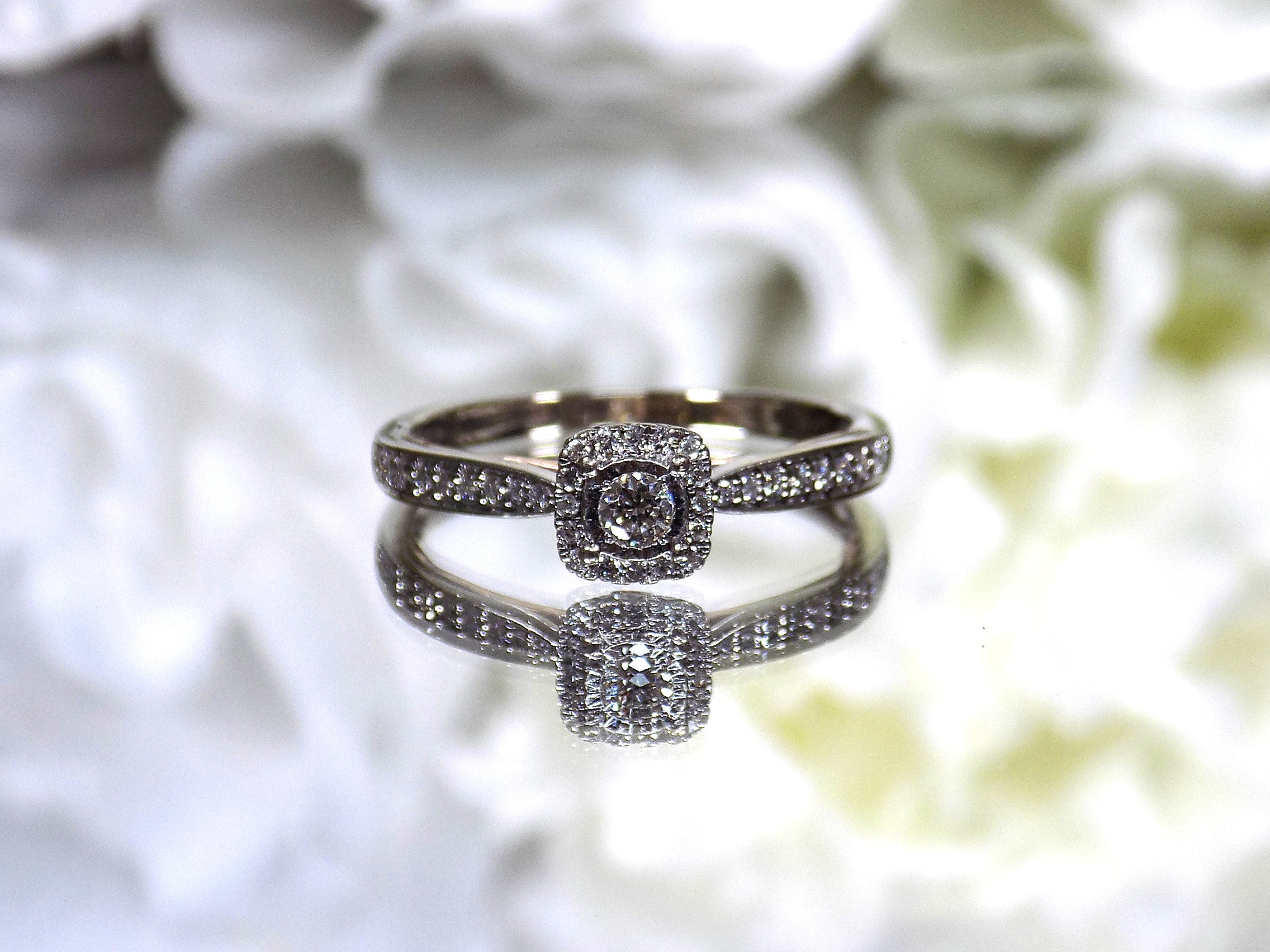 Preowned small natural diamond ring in the halo design great for promise ring or inexpensive engagement ring.