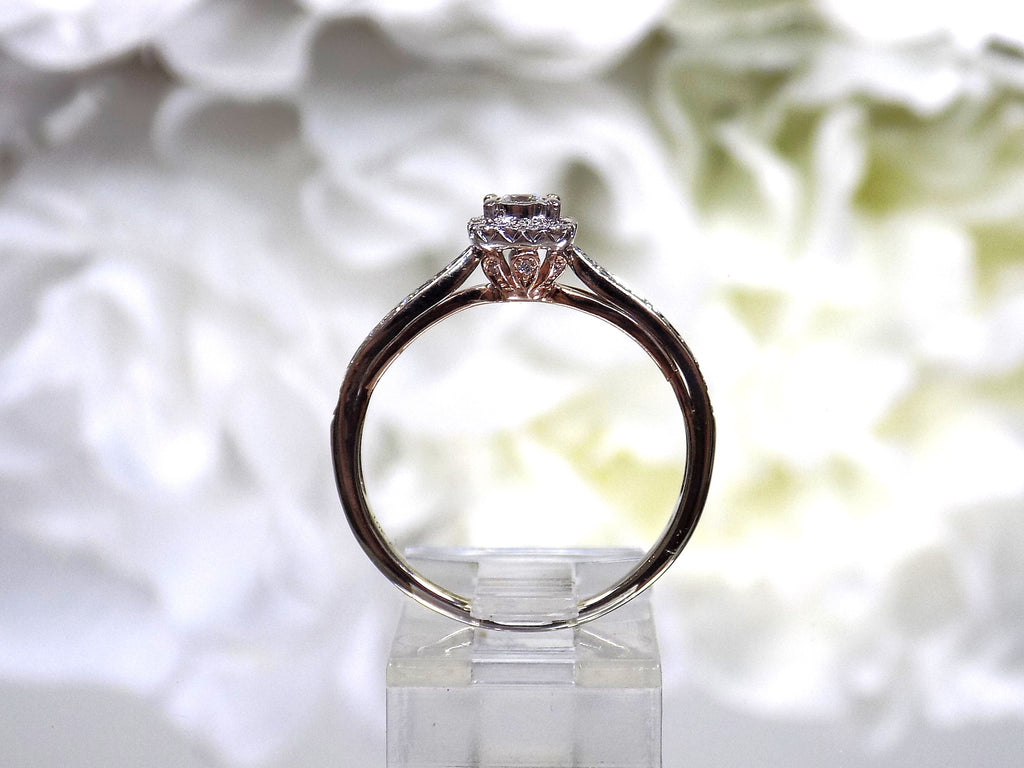 Side view of a preowned small natural diamond ring in the halo design great for promise ring or inexpensive engagement ring.