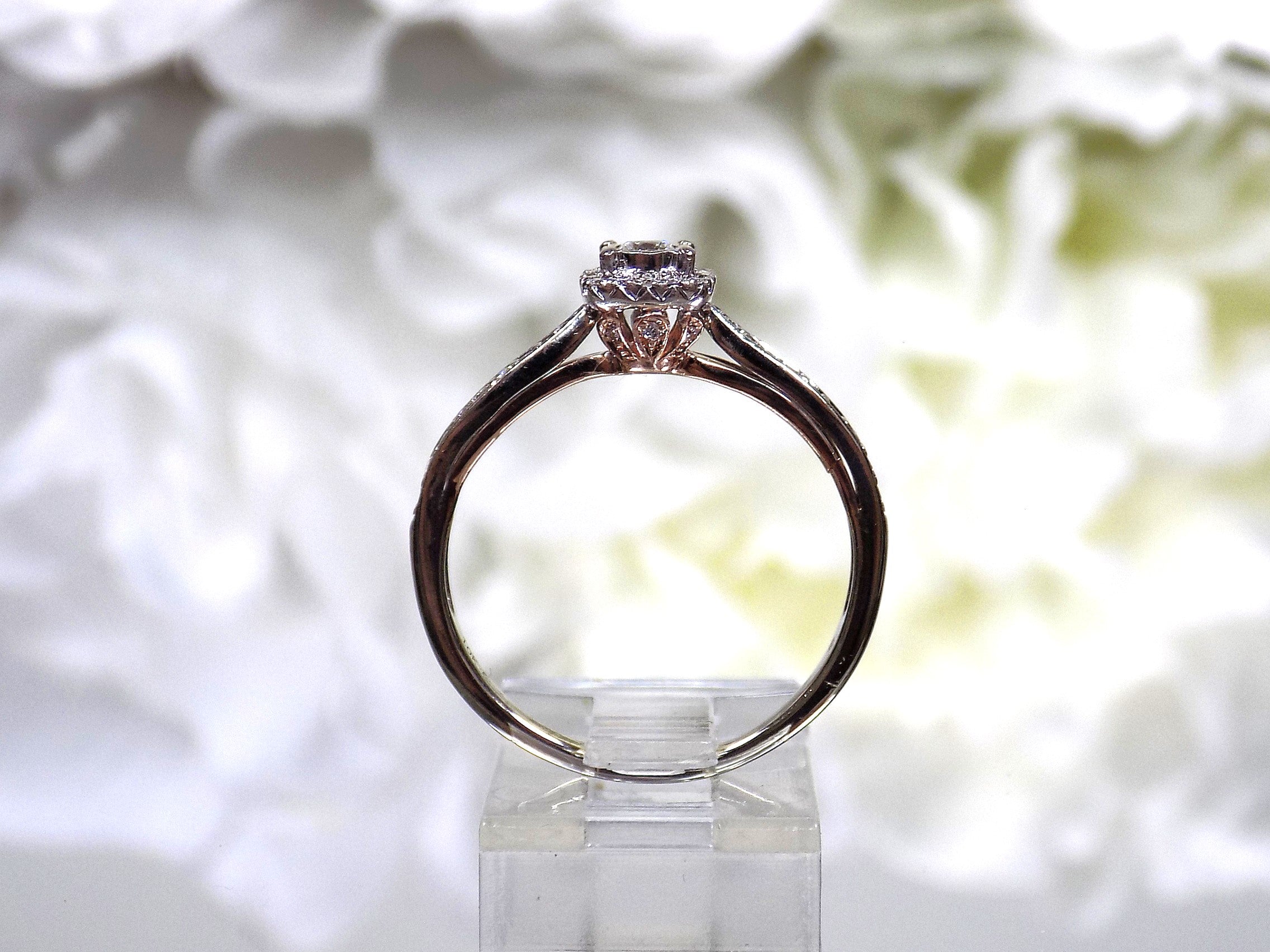 Side view of a preowned small natural diamond ring in the halo design great for promise ring or inexpensive engagement ring.