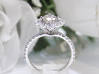 This is a 1.25ct total weight natural diamond ring with a .84ct natural round brilliant diamond in the center in white gold shown on a flowery white gold.