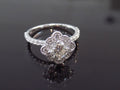 This is a 1.25ct total weight natural diamond ring with a .84ct natural round brilliant diamond in the center in white gold shown on a mirrored black background.