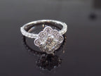 This is a 1.25ct total weight natural diamond ring with a .84ct natural round brilliant diamond in the center in white gold shown on a mirrored black background.