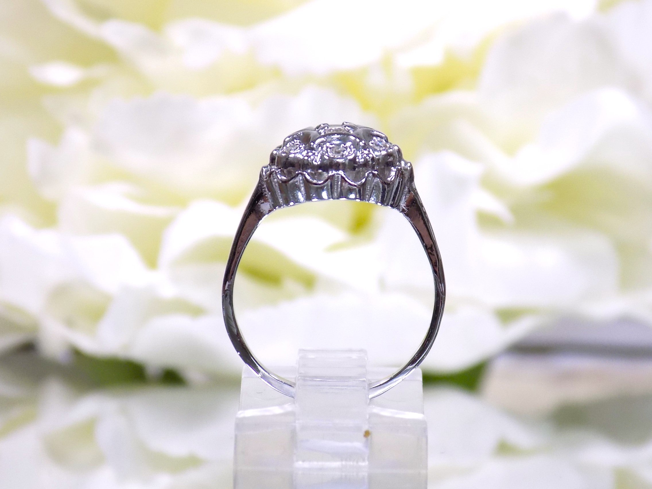 This is a side view of a 7 stone .10ct Total Weight Natural Diamond Vintage Ring in 14K White Gold.