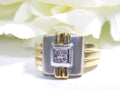 This is a woman's vintage art-deco ring that is two-tone with a brushed 18K yellow and white gold finish with .20ct total diamond weight with a floral background.
