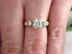This is a Vintage .59ct ladies natural diamond wedding ring in yellow gold shown on a woman's finger.