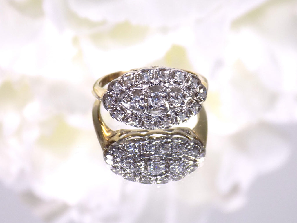 This women's ring is called "princess" style ring usually passed down from mother to daughter throughout the generations.  It a yellow gold ring with diamonds mounted in white gold in the top and has a white flowery background.