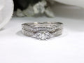 This is a two piece diamond wedding set with the ring and matching band in white gold with white background. 